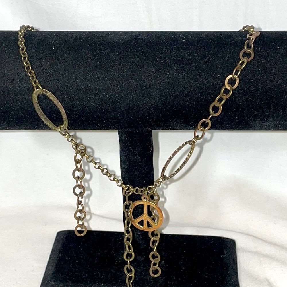 Boho necklace with assorted chains and the peace sign